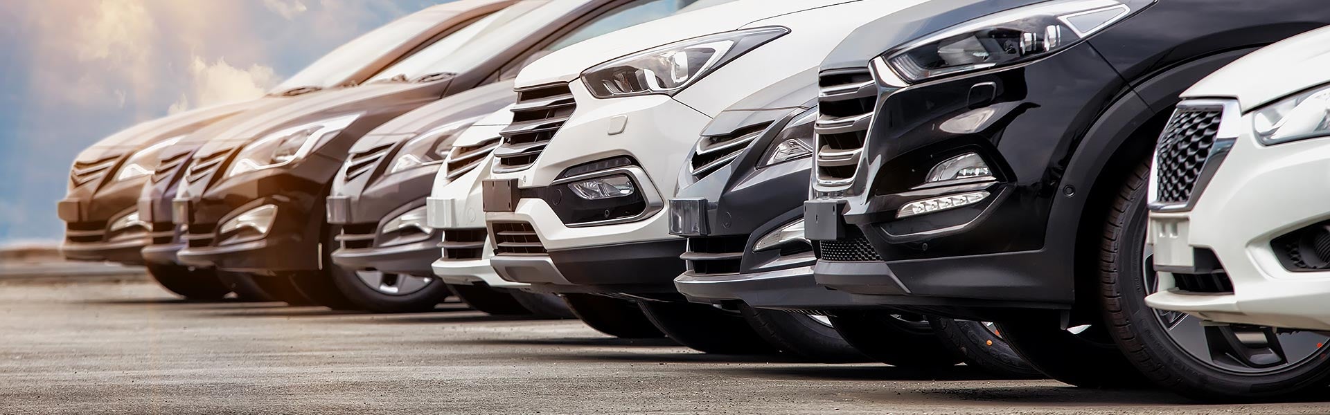 Row of new SUVs at a dealership.